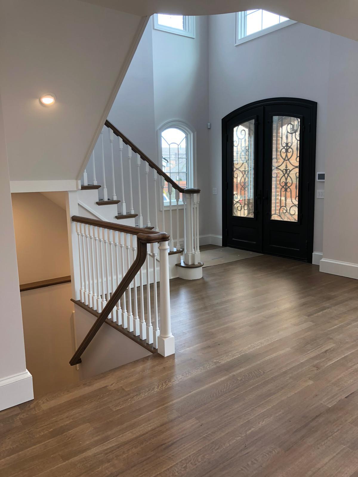 Bright two-story entry with hardwood floors