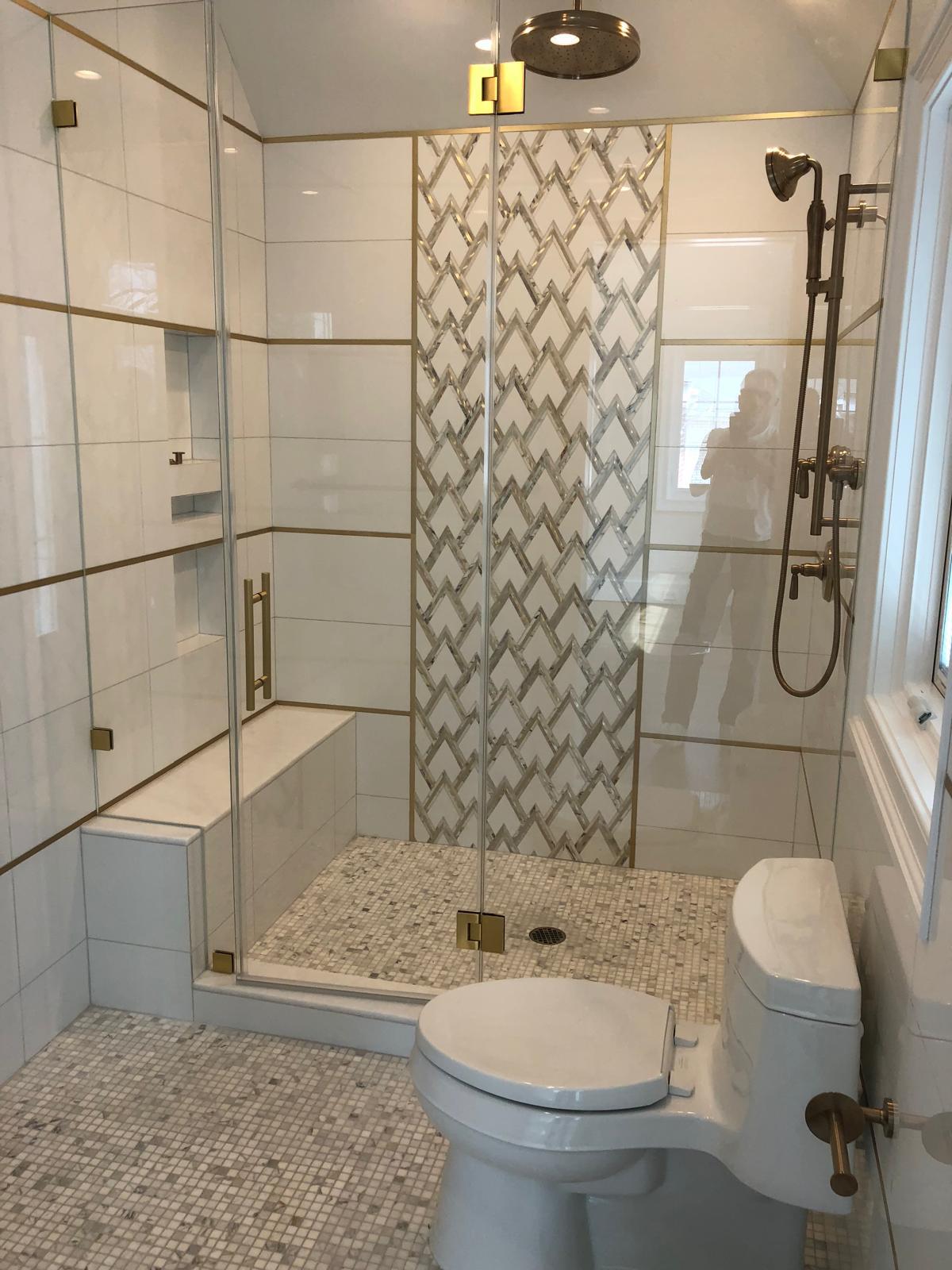 Master bath with herringbone marble feature wall